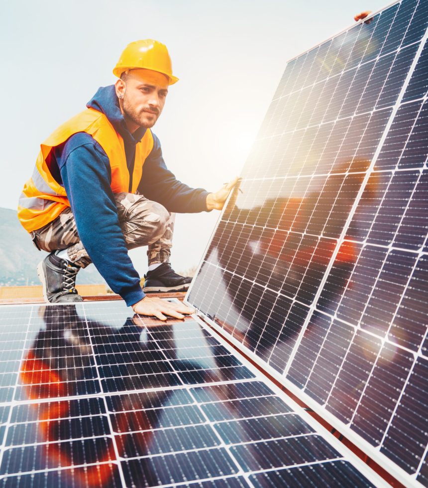 Workers assemble system with solar panel for electricity